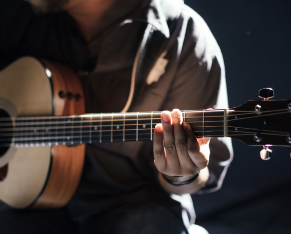 Close up of guitar player